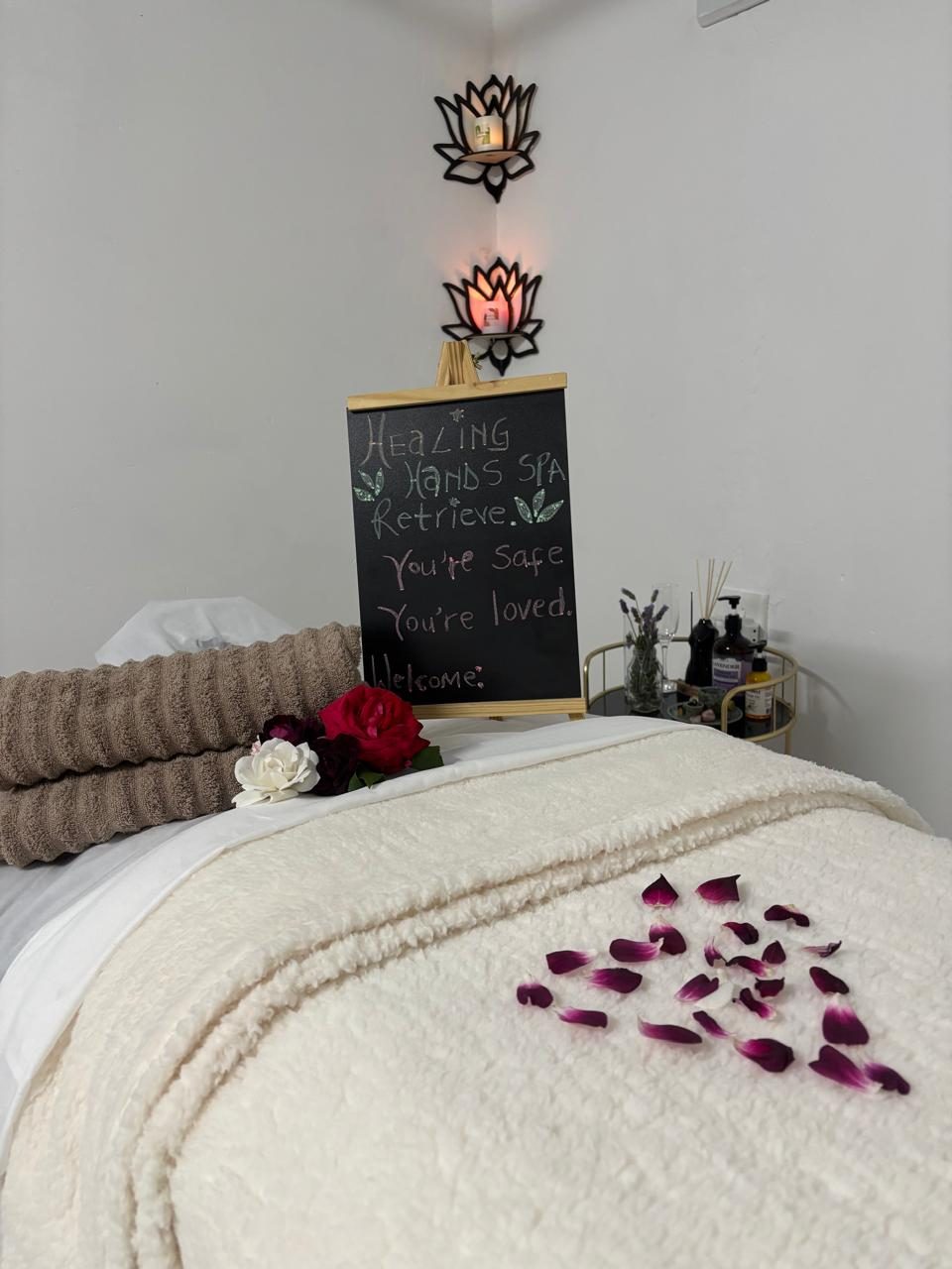 A hand-written chalkboard reading you're safe, you're loved, beside fresh roses