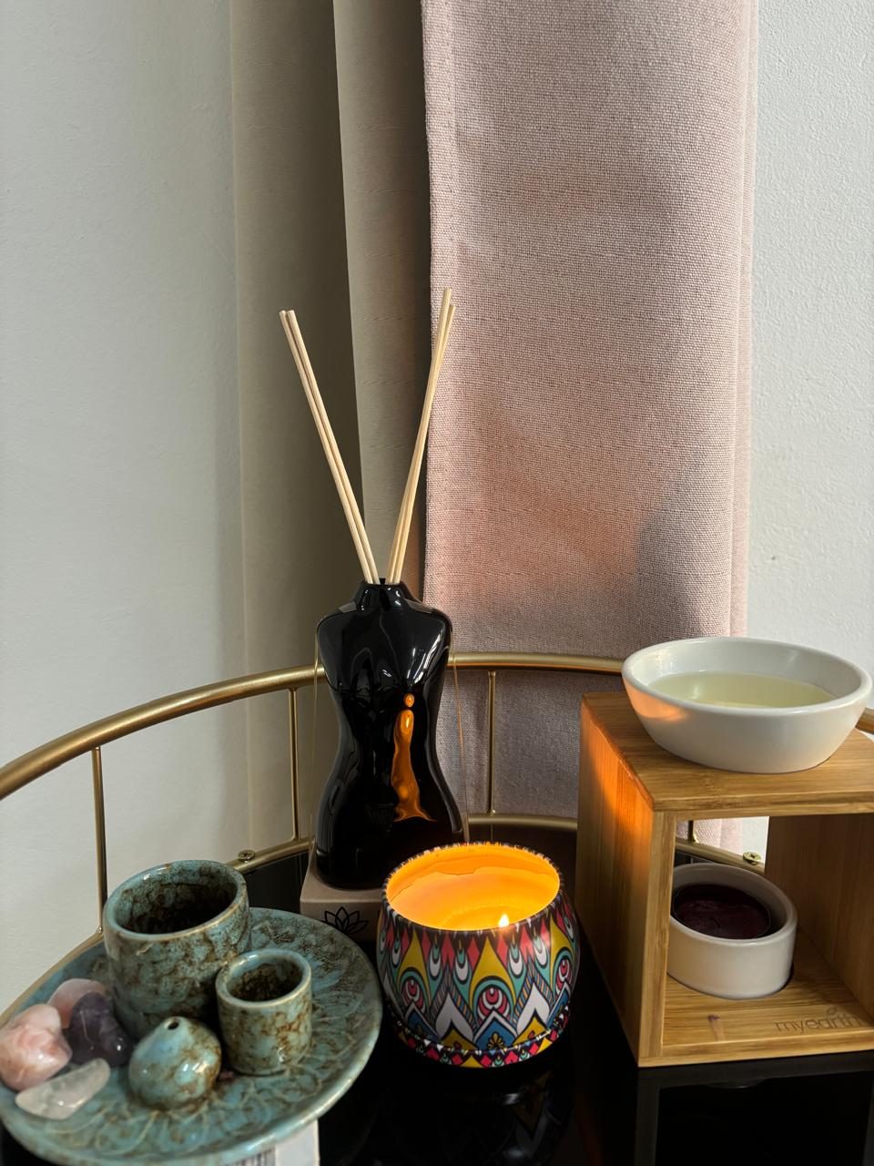 Reed diffuser and healing crystals on a side table