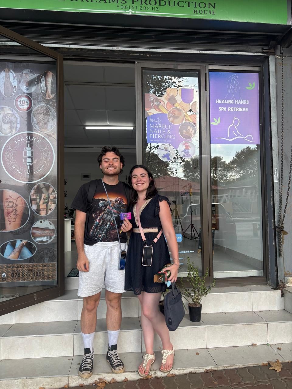 Two happy clients outside the Lee Dreams storefront
