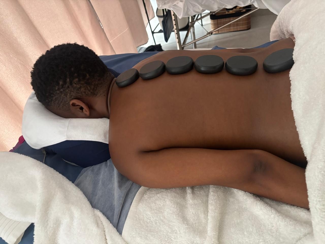 Hot stone massage laid along a client's back
