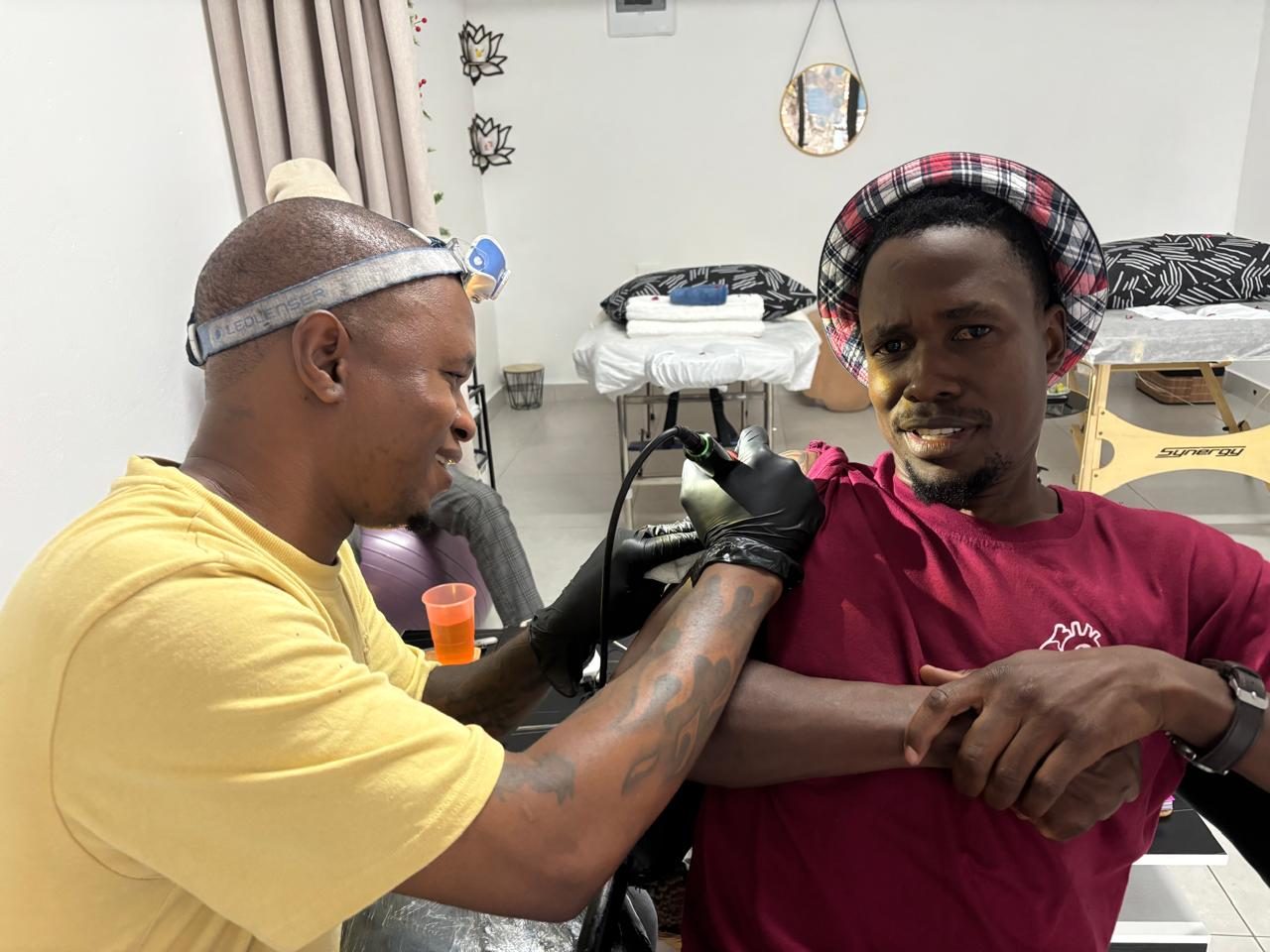 Ink Slice tattoo artist at work on a client's arm