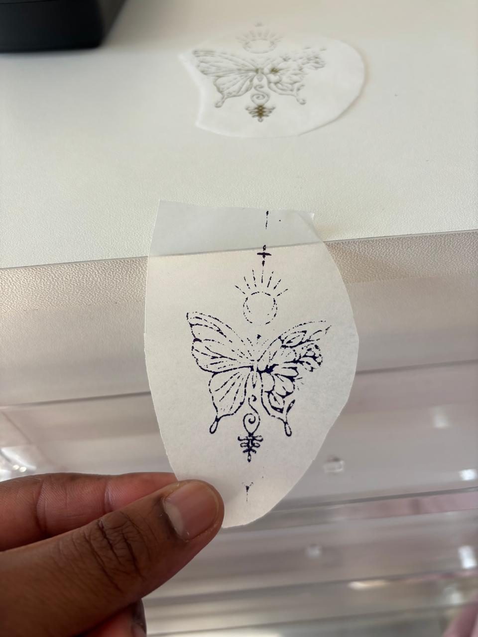 A butterfly tattoo stencil ready to be applied