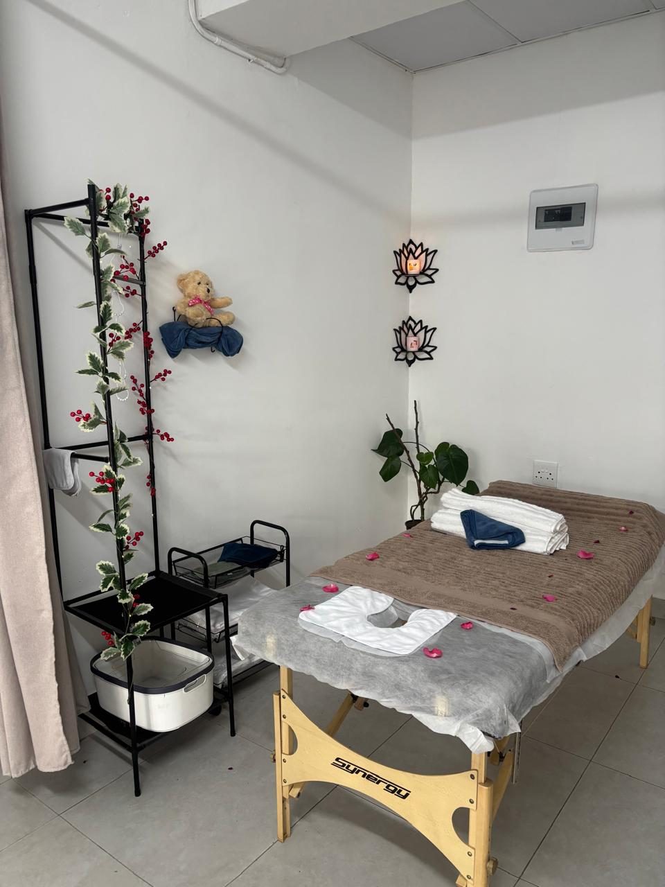 A styled treatment room with lotus candle sconces